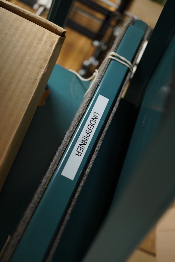 An Underpinner with two dissembled ‘arms’ and a box containing tools, accessories and manual